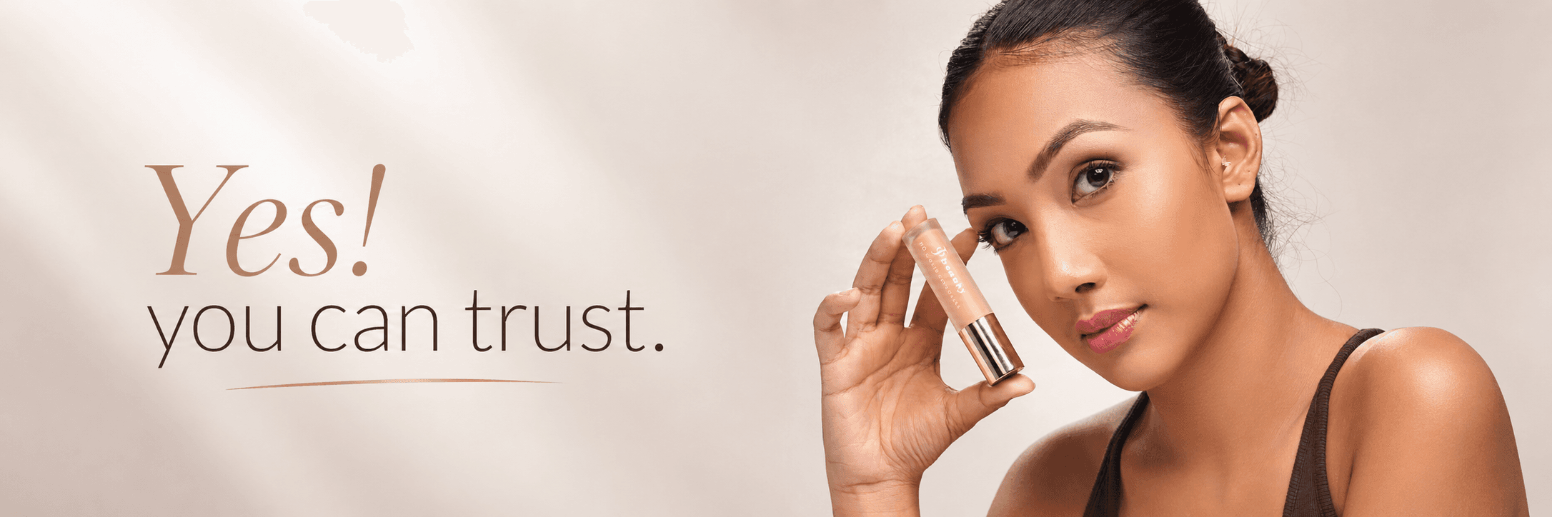 A jo. beauty model holding the HD concealer wand against her cheek